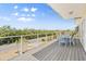 Outdoor deck with stylish seating, offering scenic views of the neighborhood and lush greenery at 4717 Lemon Bay Dr, Venice, FL 34293