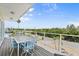 Outdoor deck with stylish seating, offering beautiful views of the surrounding landscape and clear blue skies at 4717 Lemon Bay Dr, Venice, FL 34293