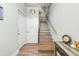 Bright entryway featuring a staircase with wood treads, railing, and coastal decor at 4717 Lemon Bay Dr, Venice, FL 34293