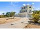 Stunning three-story home with a spacious driveway and multiple balconies at 4717 Lemon Bay Dr, Venice, FL 34293