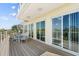Exterior view of the home featuring an outdoor deck with stylish furniture and sliding glass doors at 4717 Lemon Bay Dr, Venice, FL 34293