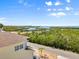 Scenic neighborhood view from a charming home with lush greenery and glimpses of the intercoastal waterway at 4717 Lemon Bay Dr, Venice, FL 34293
