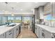 Bright, modern kitchen featuring an island with seating, a dining area, and stainless steel appliances at 4717 Lemon Bay Dr, Venice, FL 34293