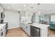 Updated kitchen with gray cabinets, stainless steel appliances, a quartz countertop island and a cozy seating area at 4717 Lemon Bay Dr, Venice, FL 34293