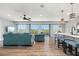 Spacious living room featuring modern decor, wood floors, large windows with natural light, and an open floor plan at 4717 Lemon Bay Dr, Venice, FL 34293