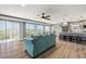 Open-concept living area with comfortable seating, modern decor, wood flooring, and an adjacent kitchen area at 4717 Lemon Bay Dr, Venice, FL 34293