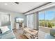 Cozy living room with a comfortable sofa, a large screen television, and access to an outdoor deck at 4717 Lemon Bay Dr, Venice, FL 34293