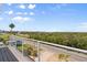 Scenic views from balcony overlooking street, trees, and water at 4717 Lemon Bay Dr, Venice, FL 34293