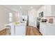Eat in kitchen boasts modern appliances, a central island, and sleek white cabinets for a contemporary feel at 5030 Rocky Coast Pl, Palmetto, FL 34221