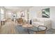 Open-concept living space with bright interiors, stylish furniture, and seamless flow into dining area at 5030 Rocky Coast Pl, Palmetto, FL 34221