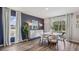 Stylish dining area featuring a modern table, chairs, and beautiful accent wall at 5034 Rocky Coast Pl, Palmetto, FL 34221