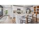Well-lit kitchen with an island featuring bar stool seating, stainless appliances, and modern fixtures at 5034 Rocky Coast Pl, Palmetto, FL 34221