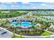 Stunning aerial view of a community pool and recreation center with lush landscaping and inviting amenities at 5037 Rocky Coast Pl, Palmetto, FL 34221
