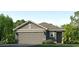 Charming single-story home with a gray exterior, landscaped yard, and an attached two-car garage at 5038 Rocky Coast Pl, Palmetto, FL 34221