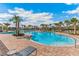 Beautiful community pool surrounded by palm trees, with plenty of space for relaxation and recreation at 5038 Rocky Coast Pl, Palmetto, FL 34221