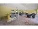 A covered outdoor community area with tables, chairs, and an outdoor kitchen with a bar at 5282 Grove Mill Loop, Bradenton, FL 34211