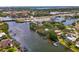 An aerial view of the property from the water showcasing the nearby bridge and community at 5377 Palos Verdes Dr, Sarasota, FL 34231