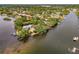 Aerial view of the property on a peninsula surrounded by water with lush landscaping at 5377 Palos Verdes Dr, Sarasota, FL 34231