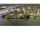 Aerial view highlighting the property's location on the water, surrounded by lush landscaping at 5377 Palos Verdes Dr, Sarasota, FL 34231