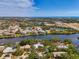 Scenic aerial view of waterfront homes surrounded by lush landscapes and tranquil waters under a blue sky at 5377 Palos Verdes Dr, Sarasota, FL 34231