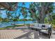 Scenic backyard overlooking the water featuring a wooden deck with comfortable lounge seating at 5377 Palos Verdes Dr, Sarasota, FL 34231