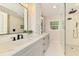 Modern bathroom featuring dual sinks, marble countertops, and a glass-enclosed shower for a luxurious spa experience at 5377 Palos Verdes Dr, Sarasota, FL 34231