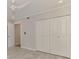 Bedroom featuring a ceiling fan, closet, and tiled floors at 5377 Palos Verdes Dr, Sarasota, FL 34231