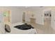 Bright bedroom featuring tiled floor, an ensuite bathroom, and walk-in closet at 5377 Palos Verdes Dr, Sarasota, FL 34231