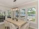 Bright dining area with water view through the windows and French doors at 5377 Palos Verdes Dr, Sarasota, FL 34231