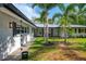 Charming exterior with well manicured lawn and tropical landscaping at 5377 Palos Verdes Dr, Sarasota, FL 34231