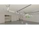 Spacious garage with painted floor, overhead lighting, and ample storage space at 5377 Palos Verdes Dr, Sarasota, FL 34231