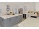 Open kitchen showcasing a large island, wine storage, stainless appliances, and modern white and gray cabinetry at 5377 Palos Verdes Dr, Sarasota, FL 34231