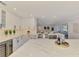 Contemporary kitchen with wine fridge, modern appliances, open layout, and large island with marble countertops at 5377 Palos Verdes Dr, Sarasota, FL 34231