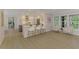 Open-concept view of the kitchen and kitchen island that features modern appliances and bar stool seating at 5377 Palos Verdes Dr, Sarasota, FL 34231