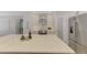 Modern kitchen island with stainless appliances, white cabinetry, and marble countertops, adjacent to modern refrigerator at 5377 Palos Verdes Dr, Sarasota, FL 34231