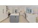 Spacious kitchen with modern appliances, large central island, sleek white cabinetry, and bright, open layout at 5377 Palos Verdes Dr, Sarasota, FL 34231