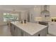 Bright kitchen boasts a large island with quartz countertops and stainless steel appliances, perfect for culinary enthusiasts at 5377 Palos Verdes Dr, Sarasota, FL 34231