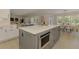 Spacious kitchen with stainless appliances and white and gray cabinets, complemented by a large island at 5377 Palos Verdes Dr, Sarasota, FL 34231