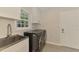 Laundry room with modern washer/dryer, sink and ample cabinet storage at 5377 Palos Verdes Dr, Sarasota, FL 34231