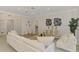 Cozy living room with white furnishings, modern art, and a view into the hall at 5377 Palos Verdes Dr, Sarasota, FL 34231