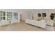 Bright living room with modern tile flooring, white furnishings, and large windows offering exterior views at 5377 Palos Verdes Dr, Sarasota, FL 34231