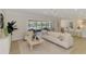 Inviting living room with stylish decor, overlooking a screened lanai and serene water views at 5377 Palos Verdes Dr, Sarasota, FL 34231