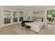 Tranquil main bedroom with natural light through French doors, complemented by stylish decor for serene relaxation at 5377 Palos Verdes Dr, Sarasota, FL 34231