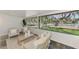 Inviting sunroom with wicker furniture offers scenic waterfront views for relaxation and enjoyment at 5377 Palos Verdes Dr, Sarasota, FL 34231