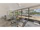 Waterfront view from the screened-in lanai/sunroom with dining and lounging areas at 5377 Palos Verdes Dr, Sarasota, FL 34231