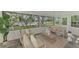 Relaxing sunroom featuring comfortable seating and serene waterfront views perfect for unwinding at 5377 Palos Verdes Dr, Sarasota, FL 34231