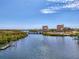 Scenic water view showcasing nearby buildings, a bridge and dock under a beautiful sky at 5377 Palos Verdes Dr, Sarasota, FL 34231