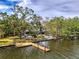 Picturesque waterfront home with private dock, showcasing serene water views and mature trees at 5377 Palos Verdes Dr, Sarasota, FL 34231