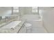 Bathroom featuring granite countertops, soaking tub and new fixtures at 5388 Davini St, Sarasota, FL 34238