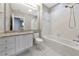 Bathroom with granite vanity, mirror, tub and tiled shower at 5388 Davini St, Sarasota, FL 34238